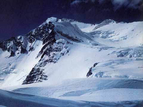 
The summit of Gasherbrum I (Hidden Peak) from Camp IV in 1958, over 4,000 feet higher and miles of soft snow away. The first ascent route went up the plateau between Hidden South and Urdok Peak - A Walk In The Sky book
